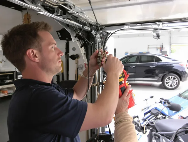 Garden City Garage Door Repair safety certified technician performing cable replacement in Garden City