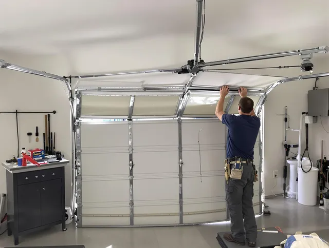 Garden City Garage Door Repair specialist performing precise section replacement on Garden City garage door